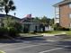 Condo exterior featuring beautiful landscaping, American flag, and easy parking at 3955 Gladiola Ct. # 301, Myrtle Beach, SC 29588