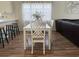 Bright dining area with a white table and chairs, adjacent to the kitchen and living room at 3955 Gladiola Ct. # 301, Myrtle Beach, SC 29588
