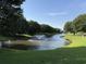 Picturesque pond view featuring a fountain surrounded by lush greenery at 3955 Gladiola Ct. # 301, Myrtle Beach, SC 29588