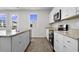 Bright kitchen with white cabinets and stainless steel appliances, with a large window at 409 Falling Leaf Loop, Myrtle Beach, SC 29588