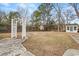 Exterior view of backyard featuring an arbor and outbuildings and an expansive grassy lawn at 410 Martin St., Mullins, SC 29574