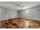 The bedroom has beautiful wood floors, a ceiling fan, shelves, and a window for natural light at 410 Martin St., Mullins, SC 29574