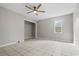 This bedroom features tile flooring, neutral paint, a ceiling fan, and a closet for storage at 410 Martin St., Mullins, SC 29574