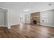 Bright living room featuring hardwood floors and a brick fireplace, perfect for cozy evenings at 410 Martin St., Mullins, SC 29574