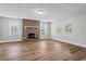 Spacious living room with hardwood floors and a brick fireplace, bathed in natural light at 410 Martin St., Mullins, SC 29574