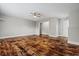 Open-concept living room with attractive wood floors, neutral paint, and an entry to another room at 410 Martin St., Mullins, SC 29574