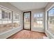 Sunroom with wood-look floors, multiple windows offering views of the exterior of the home at 410 Martin St., Mullins, SC 29574