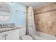 Well-lit bathroom features a granite countertop and a shower with tiled walls at 4111 Ocean Blvd. S # 402, North Myrtle Beach, SC 29582