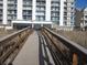 Exterior shot of building with beach access via wooden boardwalk at 4111 Ocean Blvd. S # 402, North Myrtle Beach, SC 29582