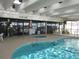 Relax by the light-filled indoor pool featuring a hot tub, easy access ladders, and comfortable poolside seating at 4111 Ocean Blvd. S # 402, North Myrtle Beach, SC 29582