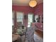 Dining room featuring pink walls, a glass table, and views of the outdoor garden at 4115 Little River Rd., Myrtle Beach, SC 29577