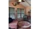 Cozy sunroom featuring terracotta tile floor, unique decor, and bright natural light at 4115 Little River Rd., Myrtle Beach, SC 29577