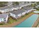 Aerial view of a condo building next to a pond and swimming pool at 4140 Hibiscus Dr. # 303, Little River, SC 29566