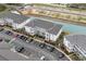 Aerial view of the condos, parking lot, and nearby pond, showcasing community layout at 4140 Hibiscus Dr. # 303, Little River, SC 29566