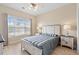 Bright main bedroom featuring a queen bed, two bedside tables and plenty of natural light at 4140 Hibiscus Dr. # 303, Little River, SC 29566