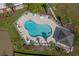 Aerial view of a sparkling pool, complete with lounge chairs, tables, and manicured landscaping at 4140 Hibiscus Dr. # 303, Little River, SC 29566