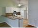 Bright kitchen with white cabinetry, granite countertops, and stainless steel appliances at 422 Cassian Way, Myrtle Beach, SC 29588