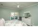 Bedroom featuring a floral bedspread, white dresser and a sliding glass door leading to a balcony with seating at 4220 Coquina Harbour Dr. # B-12, Little River, SC 29566