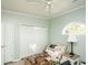 Bedroom with white trim, light green walls, closet, ceiling fan, and a half-moon window at 4220 Coquina Harbour Dr. # B-12, Little River, SC 29566