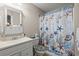 Nautical themed bathroom features a decorative shower curtain, toilet seat and seashell accents at 4309 River Gate Ln., Little River, SC 29566