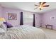 Cozy bedroom featuring a ceiling fan, neutral carpet and charming lavender walls at 4309 River Gate Ln., Little River, SC 29566