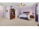 Cozy bedroom featuring lavender walls, ceiling fan and access to ensuite bathroom at 4309 River Gate Ln., Little River, SC 29566