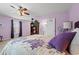 Close up of lavender bedroom featuring a ceiling fan, window and decorative pillows at 4309 River Gate Ln., Little River, SC 29566