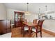 Elegant dining area featuring hardwood floors, a china cabinet, and adjacent kitchen view at 4309 River Gate Ln., Little River, SC 29566