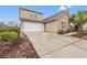 Exterior view of a home with a two-car garage and a well-maintained driveway at 4309 River Gate Ln., Little River, SC 29566