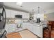 Charming kitchen with white cabinets, modern appliances, and a view into the dining area at 4309 River Gate Ln., Little River, SC 29566