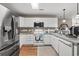 Bright kitchen featuring white cabinetry, stainless steel appliances, and granite countertops at 4309 River Gate Ln., Little River, SC 29566