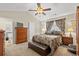 Cozy primary bedroom with vaulted ceiling, decorative fan and ensuite bathroom at 4309 River Gate Ln., Little River, SC 29566