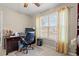 Bright office with a large window, tan carpet, and a functional workspace setup at 4309 River Gate Ln., Little River, SC 29566