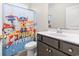 Charming bathroom features a playful Paw Patrol shower curtain and a modern vanity, perfect for a  at 453 Rycola Circle, Surfside Beach, SC 29575