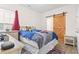 Bedroom with a rustic sliding barn door, offering a unique style element, with a desk and decorated bed nearby at 453 Rycola Circle, Surfside Beach, SC 29575