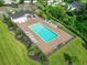 Aerial view of the community pool with lounge chairs, landscaping, and a clubhouse at 453 Rycola Circle, Surfside Beach, SC 29575