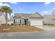 Charming home with a two-car garage, manicured lawn, and a welcoming front entrance at 453 Rycola Circle, Surfside Beach, SC 29575