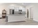 Modern kitchen island with granite countertops, stainless steel appliances and gray wood-style floors at 453 Rycola Circle, Surfside Beach, SC 29575