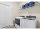 Efficient laundry room features a modern washer and dryer with convenient shelving above for storage solutions at 453 Rycola Circle, Surfside Beach, SC 29575