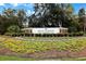 Pawleys Plantation Golf and Country Club sign framed by colorful flowers, trees, and brick accents at 48 Twelve Oaks Dr. # 2, Pawleys Island, SC 29585