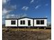 New manufactured home featuring white siding, black trim, and steps leading to the front door at 495 N Green Sea Rd., Loris, SC 29569