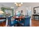 Cozy dining area with wood table, chandelier, and seating with a view of the living room at 5751 Oyster Catcher Dr. # 633, North Myrtle Beach, SC 29582