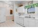 View of a bright kitchen area featuring white cabinetry and white appliances at 5751 Oyster Catcher Dr. # 633, North Myrtle Beach, SC 29582