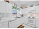 Well-lit kitchen area showcasing white cabinetry, modern appliances and a sink with window at 5751 Oyster Catcher Dr. # 633, North Myrtle Beach, SC 29582