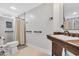 Bright bathroom featuring a wood vanity and tiled shower with grab bars at 602 Sea Vista Ln., North Myrtle Beach, SC 29582