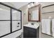 Bathroom features a dark vanity, framed mirror, and glass-enclosed shower with black trim at 602 Sea Vista Ln., North Myrtle Beach, SC 29582