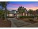 Stunning brick home at twilight with manicured landscaping and a circular driveway at 602 Sea Vista Ln., North Myrtle Beach, SC 29582