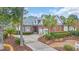 Beautiful brick home with manicured landscaping, a circular driveway, and a two-car garage at 602 Sea Vista Ln., North Myrtle Beach, SC 29582