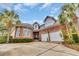 Imposing brick home showcasing a two-car garage and well-maintained landscaping at 602 Sea Vista Ln., North Myrtle Beach, SC 29582