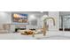 Close-up of a kitchen island with quartz countertop, modern fixtures and adjacent living room at 602 Sea Vista Ln., North Myrtle Beach, SC 29582